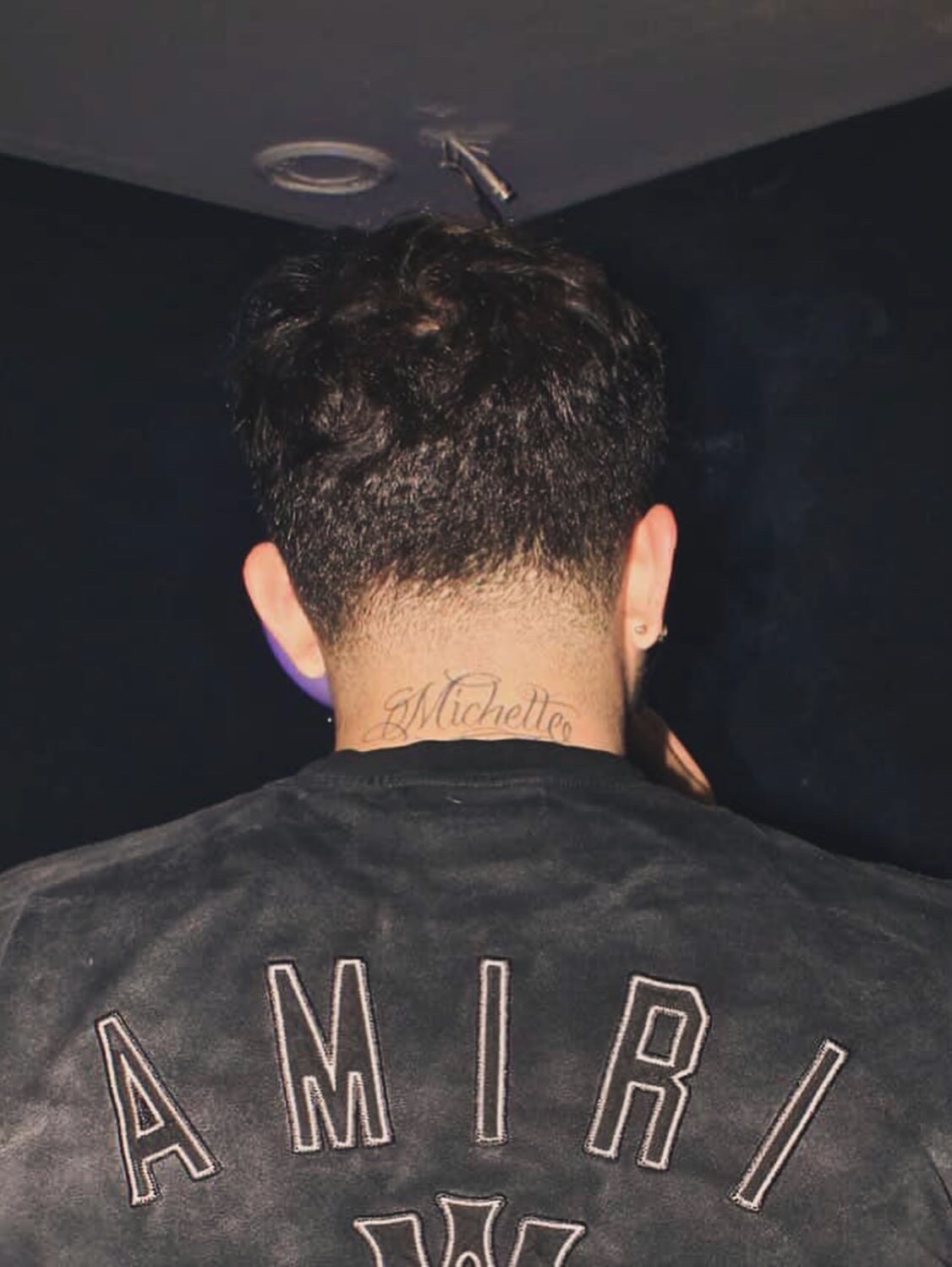 YFEGUERO photographed from behind in Amiri